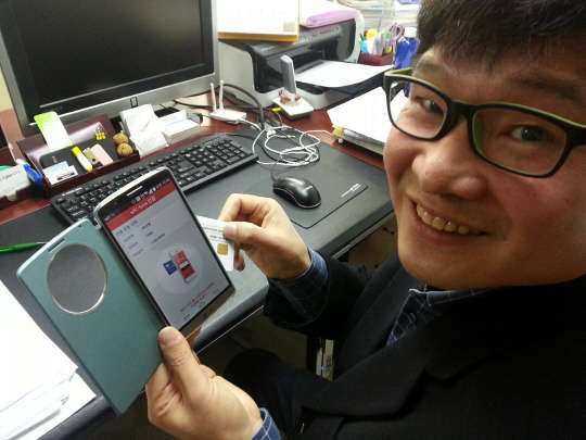 김경곤 사이버씨브이에스 대표가 카드 타입의 스마트거래연동OTP 기능을 시연해보이고 있다.